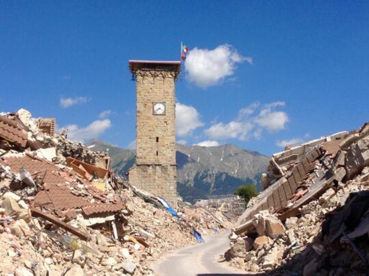 clock tower surrounded by earthquake rubble 