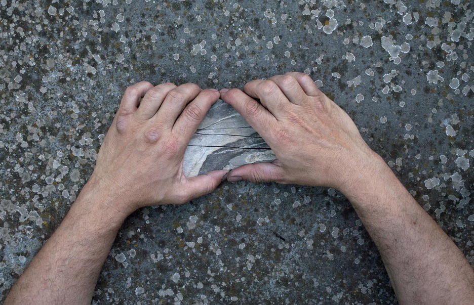 Hands holding rock 