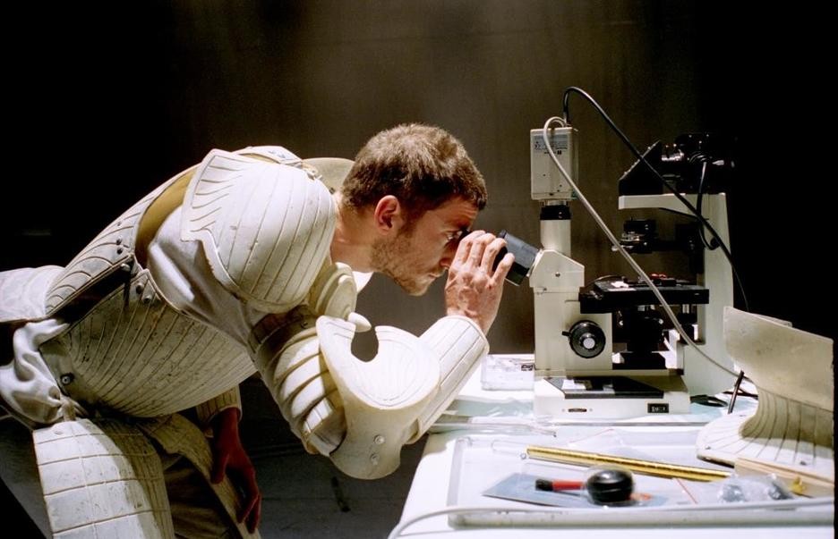 Exhibition materials - man looking through microscope