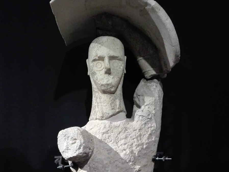 statue holding shield over head