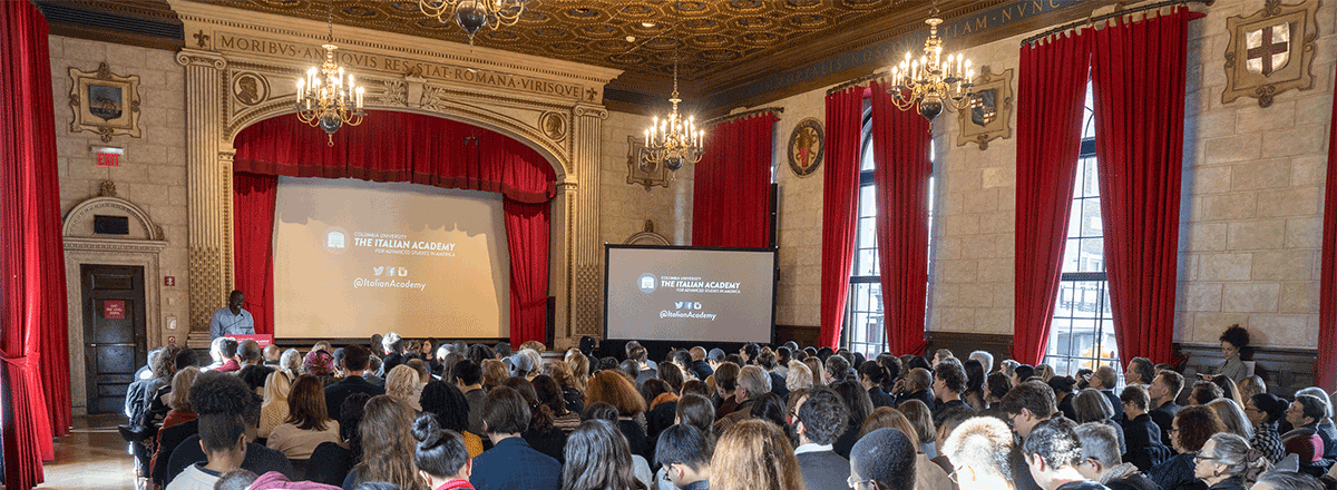 Photo of a large crowd in the Casa Italiana's Teatro for the event on art restitution.