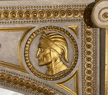 Gilded medallion portrait of Dante atop the stage of the Casa Italiana's Teatro. 