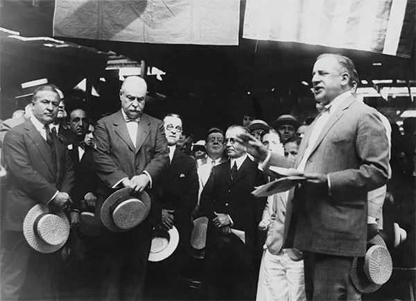Photograph of the Cornerstone Ceremony, Judge John J. Freschi speaking on the right; Joseph Paterno, the Casa's developer, and President Butler on the left.
