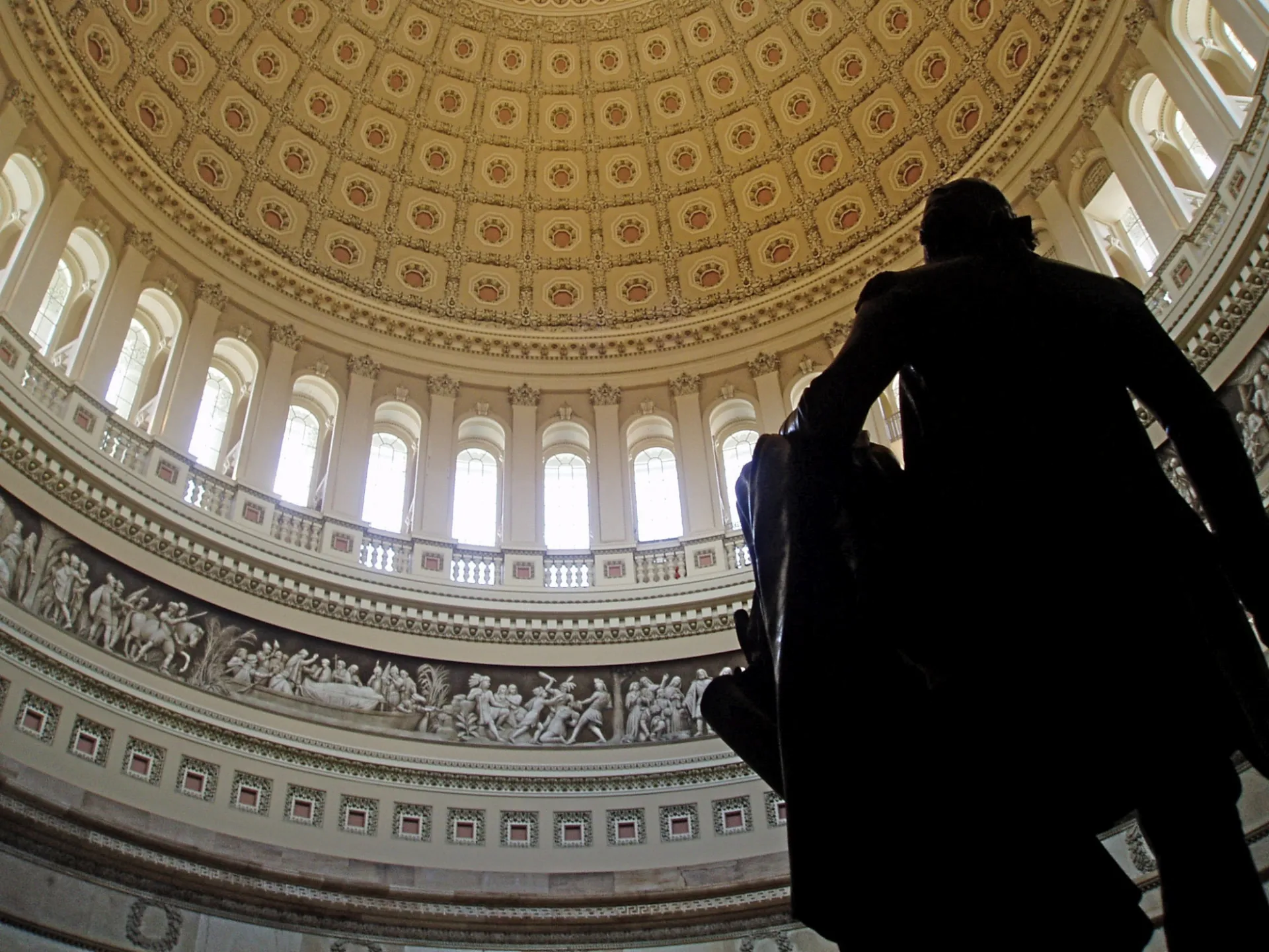 Image: Constantino Brumidi's frieze inside the United States Capitol rotunda. The Frieze of American History (1877) is 300 feet long and was started by Constantino Brumidi (1805–1880) in 1877. In the foreground here is a statue of George Washington.