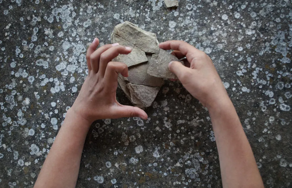 Hands holding rock