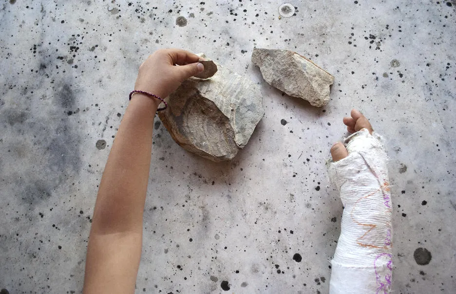 Hands holding rock 